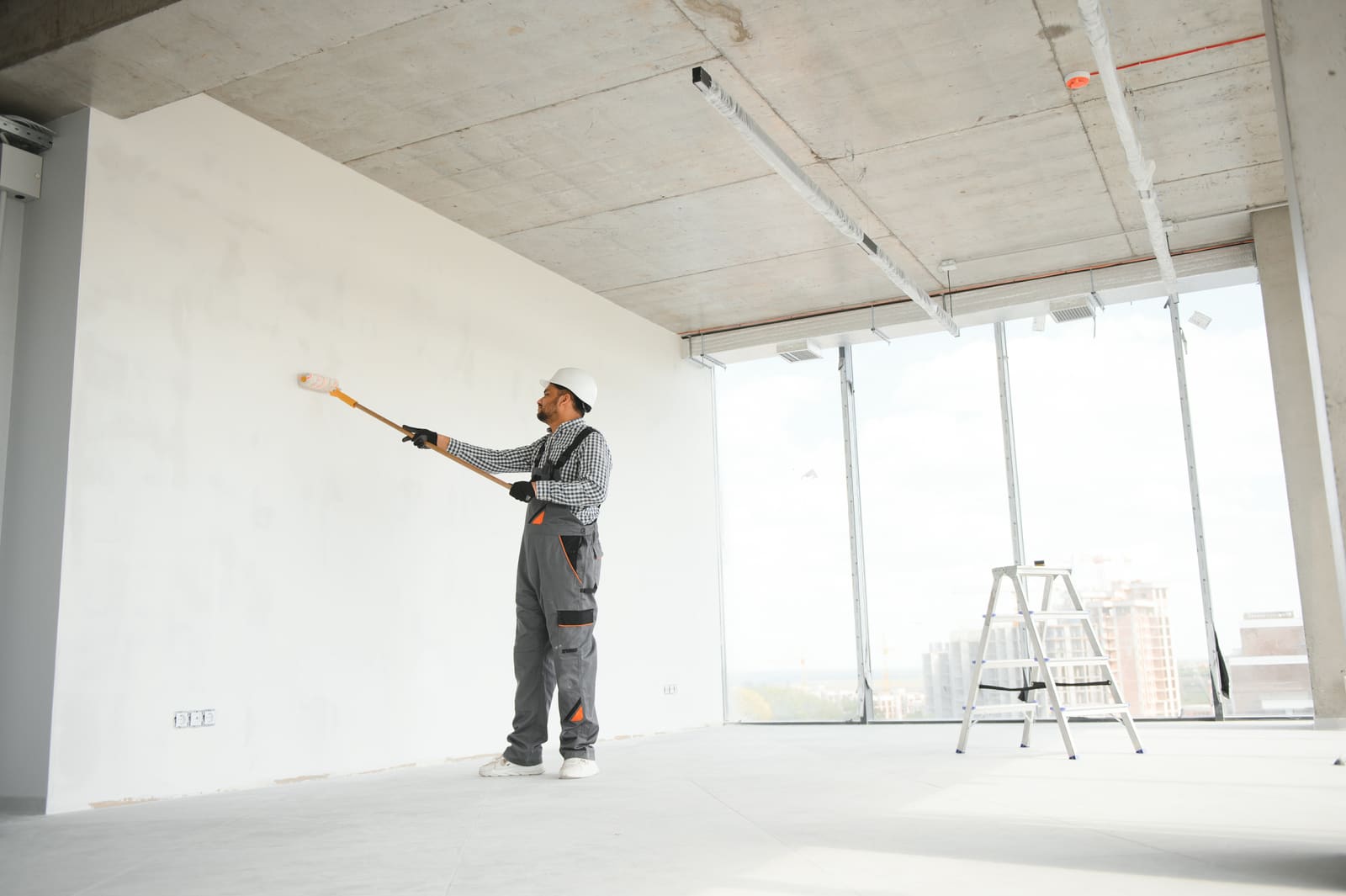 Professional painter applying interior paint in a New Jersey home